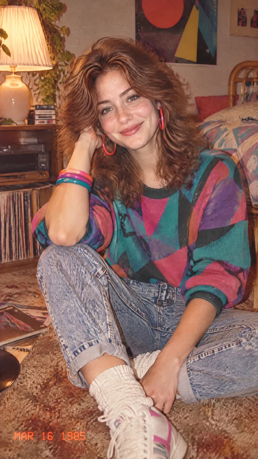 80s flashback photo of a woman with wavy auburn hair in a patterned sweater and acid-wash jeans, with film grain and an orange date stamp